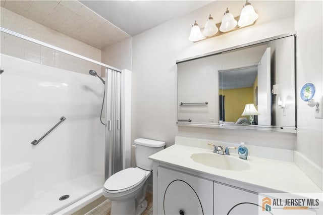 bathroom featuring toilet, a shower with shower curtain, and vanity