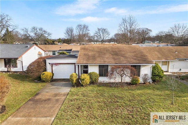 single story home featuring a garage, a front yard, and driveway