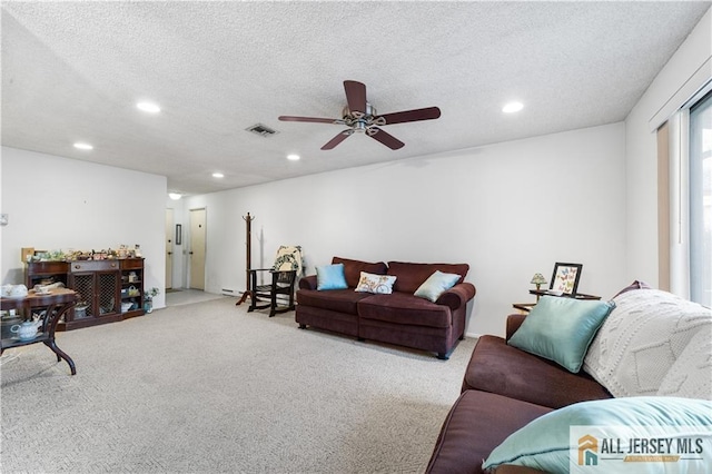 living area with a textured ceiling, carpet, visible vents, and recessed lighting