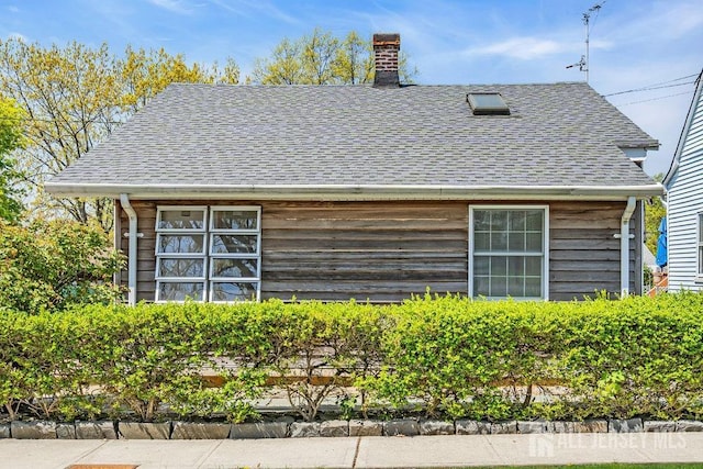 75 Lafayette St, Milltown, NJ 08850 - exterior view of a downspout, gutters, roof with shingles, and a chimney
