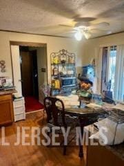 dining space featuring ceiling fan and hardwood / wood-style flooring