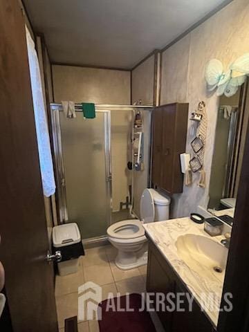 bathroom featuring toilet, a shower with door, tile patterned floors, and vanity