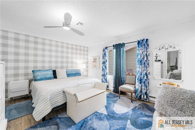 275 Convent Rd Unit 275A, Monroe, NJ 08831 - bedroom featuring wood finished floors, a textured ceiling, ceiling fan, and baseboard heating