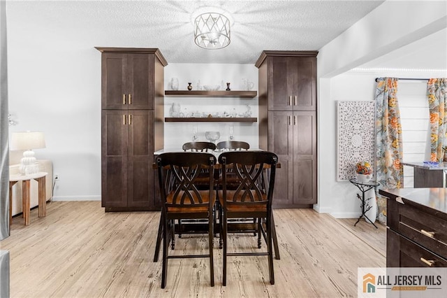 275 Convent Rd Unit 275A, Monroe, NJ 08831 - dining space featuring light wood-style floors, a chandelier, and a textured ceiling