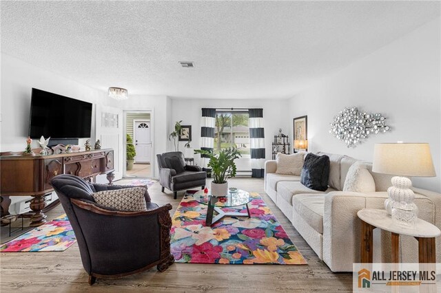 275 Convent Rd Unit 275A, Monroe, NJ 08831 - living area with wood finished floors and a textured ceiling