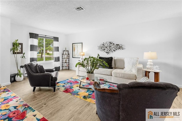 275 Convent Rd Unit 275A, Monroe, NJ 08831 - living area with wood finished floors and a textured ceiling