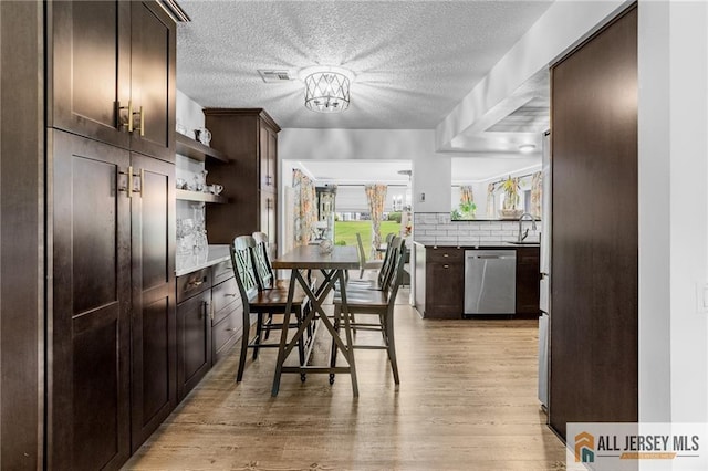 275 Convent Rd Unit 275A, Monroe, NJ 08831 - dining room featuring light wood-style floors, a textured ceiling, and a chandelier