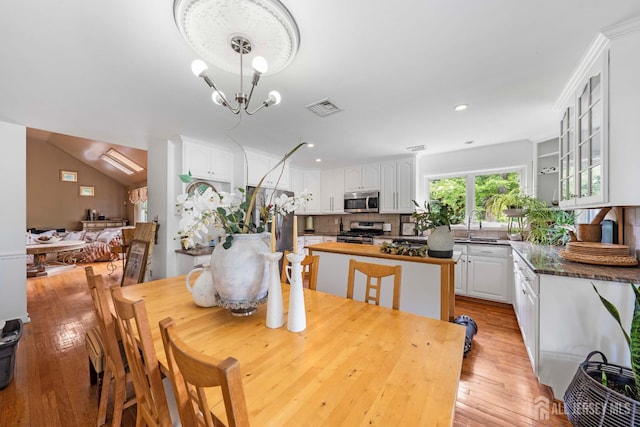 101 Weston Rd, Franklin, NJ 08873 - dining room with light wood-style flooring, recessed lighting, lofted ceiling, and a chandelier