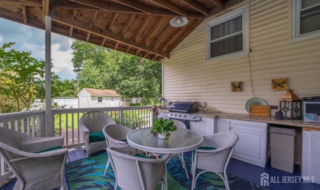 101 Weston Rd, Franklin, NJ 08873 - wooden terrace featuring outdoor dining area, a shed, and an outdoor kitchen