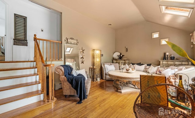 101 Weston Rd, Franklin, NJ 08873 - living room featuring light wood-type flooring, lofted ceiling, a skylight, stairway, and a baseboard radiator