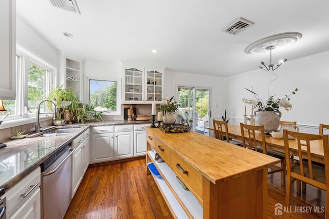 101 Weston Rd, Franklin, NJ 08873 - kitchen with stainless steel dishwasher, plenty of natural light, white cabinetry, dark wood-type flooring, and recessed lighting