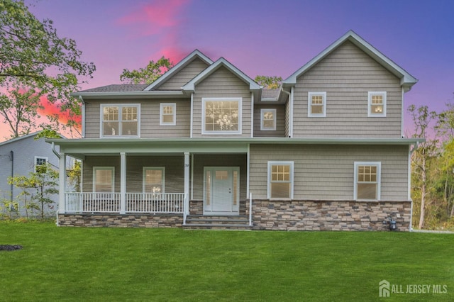 view of front of home featuring a porch and a yard