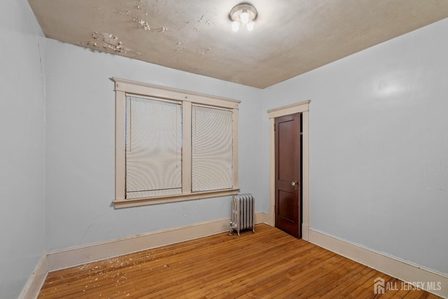 183 State St, Perth Amboy, NJ 08861 - unfurnished room featuring radiator heating unit, wood-type flooring, and baseboards