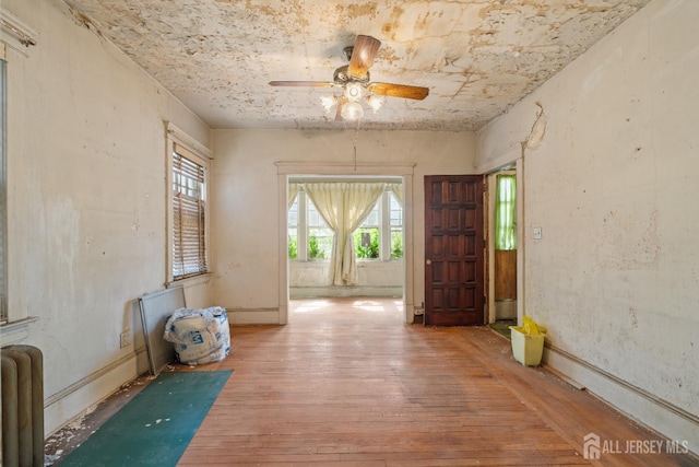183 State St, Perth Amboy, NJ 08861 - spare room with hardwood / wood-style flooring, ceiling fan, and radiator