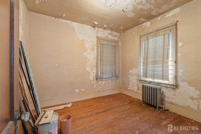 183 State St, Perth Amboy, NJ 08861 - unfurnished room featuring radiator, wood-type flooring, and baseboards