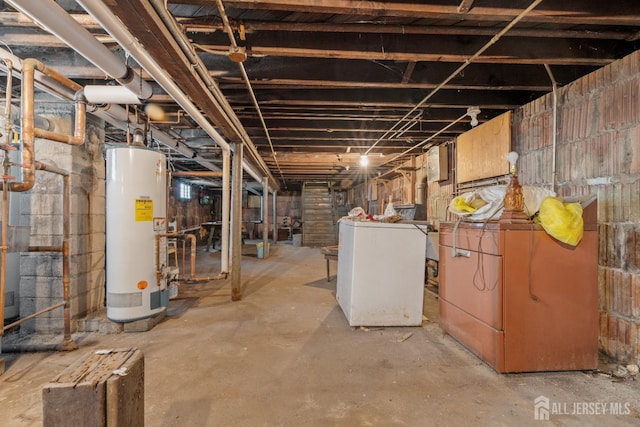 183 State St, Perth Amboy, NJ 08861 - unfinished basement with water heater, fridge, and washer / dryer