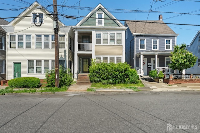 183 State St, Perth Amboy, NJ 08861 - townhome / multi-family property featuring covered porch and a chimney