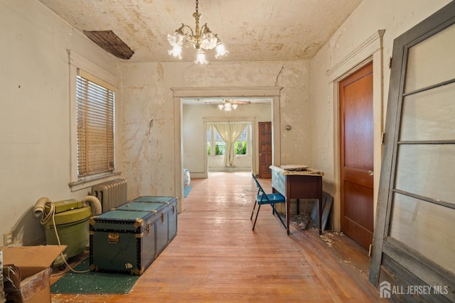 183 State St, Perth Amboy, NJ 08861 - corridor featuring hardwood / wood-style flooring, a chandelier, and radiator