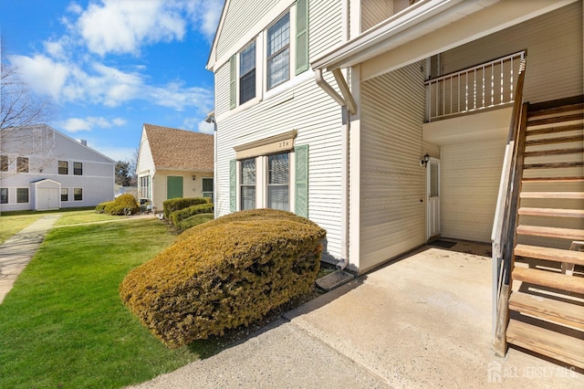 doorway to property featuring a yard