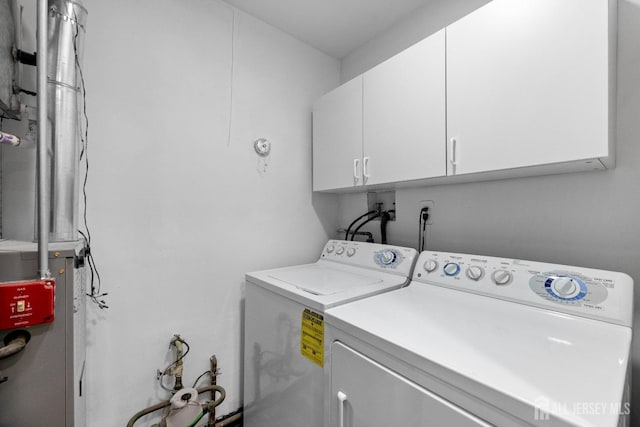 laundry area with cabinet space and washing machine and clothes dryer