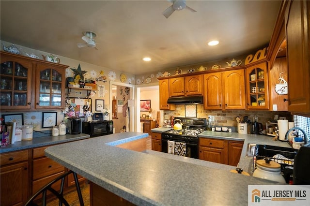 7 Cornell Rd, Old Bridge, NJ 08859 - kitchen featuring black appliances, under cabinet range hood, a ceiling fan, a sink, and glass insert cabinets