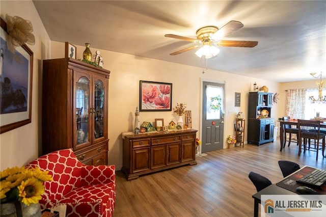 7 Cornell Rd, Old Bridge, NJ 08859 - living area with light wood-type flooring, plenty of natural light, ceiling fan, and a chandelier