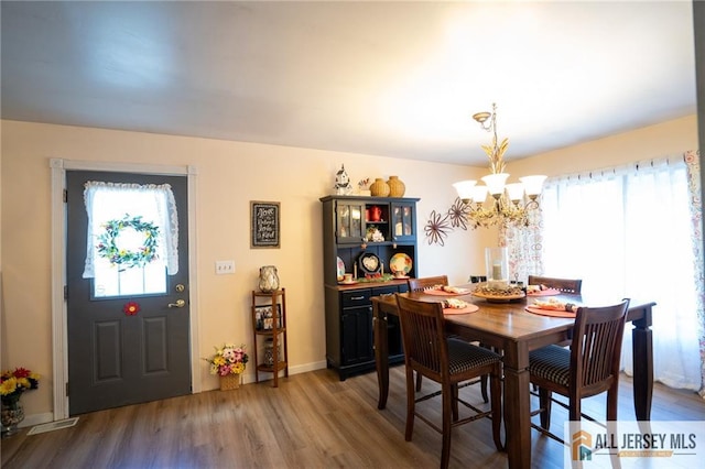 7 Cornell Rd, Old Bridge, NJ 08859 - dining space featuring a chandelier, wood finished floors, and baseboards