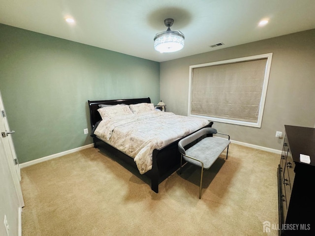 bedroom featuring visible vents, baseboards, and light colored carpet
