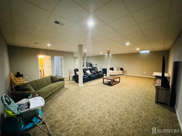 living room with carpet floors, baseboards, a paneled ceiling, and visible vents