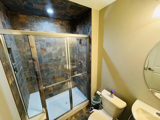 bathroom with toilet, recessed lighting, and a shower stall