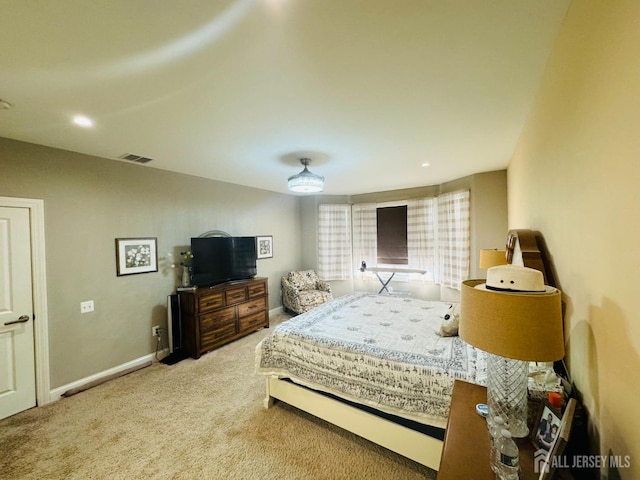 bedroom featuring carpet floors, baseboards, and visible vents