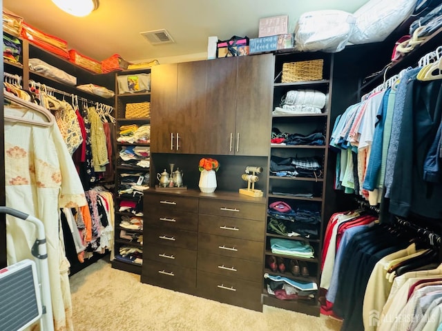 walk in closet with visible vents and carpet flooring