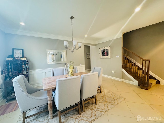 dining area with stairs, tile patterned floors, a notable chandelier, and crown molding
