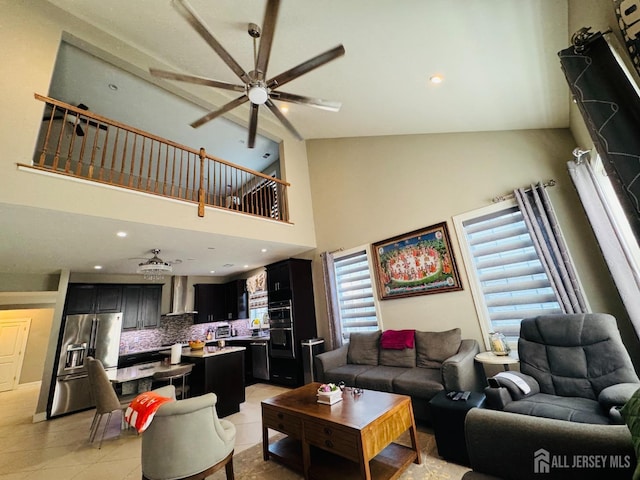 living room featuring ceiling fan, light tile patterned floors, and high vaulted ceiling