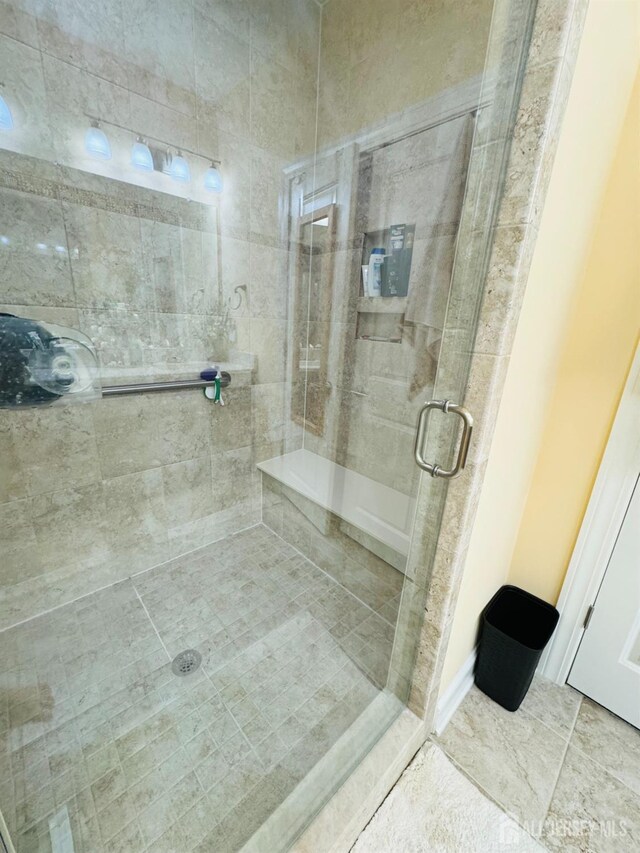 full bathroom featuring tile patterned floors and a stall shower