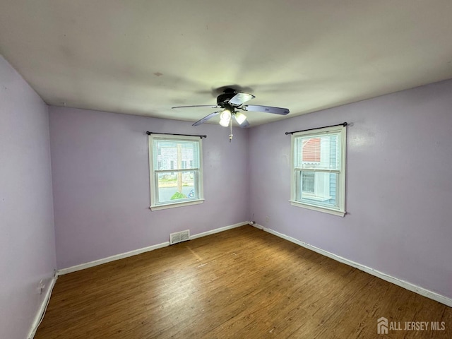 341 David St, South Amboy, NJ 08879 - empty room with plenty of natural light, wood finished floors, and ceiling fan