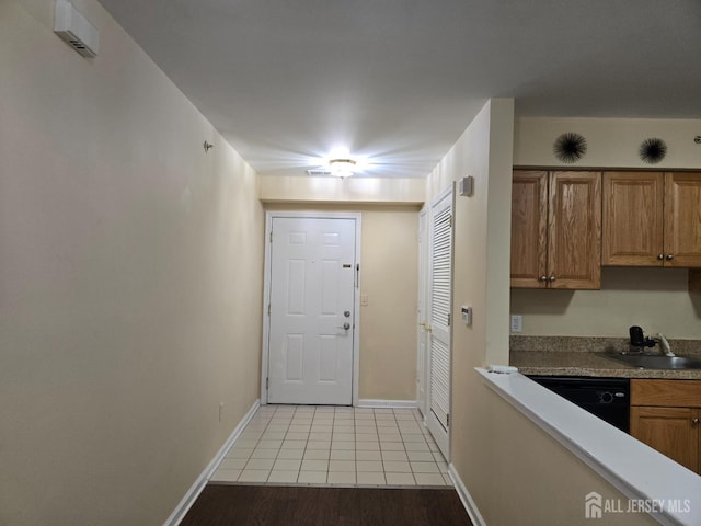 1338 Fernwood Ct, New Brunswick, NJ 08901 - doorway to outside with a sink, light tile patterned floors, and baseboards