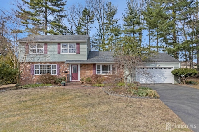 view of front of home featuring aphalt driveway, roof with shingles, an attached garage, a front lawn, and brick siding