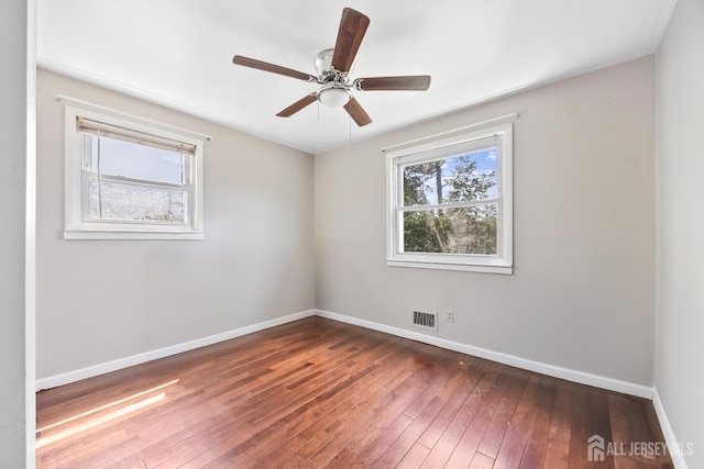 empty room with hardwood / wood-style flooring, baseboards, and ceiling fan