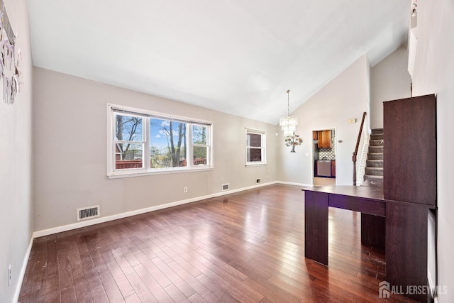 unfurnished living room featuring a chandelier, dark wood-style floors, stairs, baseboards, and high vaulted ceiling