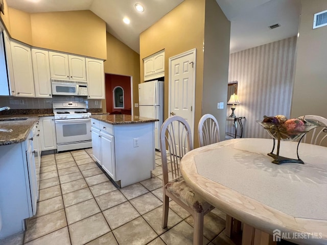 46 Dawson Ln, Monroe, NJ 08831 - kitchen featuring a center island, a sink, white cabinets, white appliances, and light tile patterned flooring