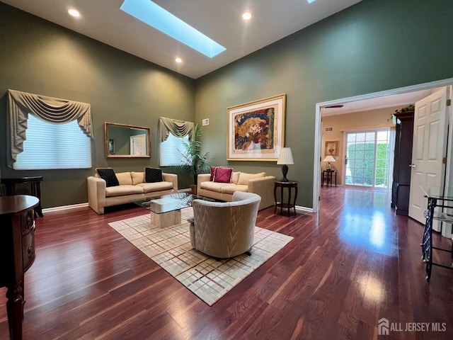 46 Dawson Ln, Monroe, NJ 08831 - living room featuring a skylight, baseboards, high vaulted ceiling, and dark wood-type flooring