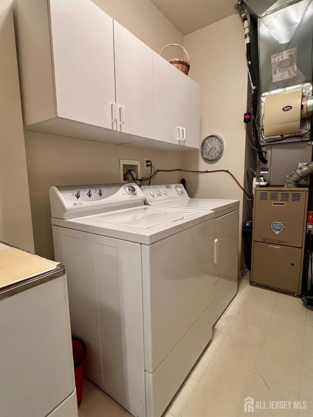 46 Dawson Ln, Monroe, NJ 08831 - clothes washing area featuring heating unit, cabinet space, and washing machine and clothes dryer
