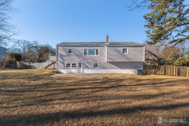 back of house with a yard, central AC unit, and a patio area