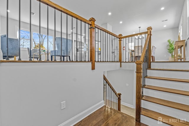 stairs with hardwood / wood-style floors