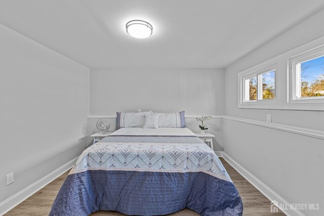 bedroom with dark wood-type flooring