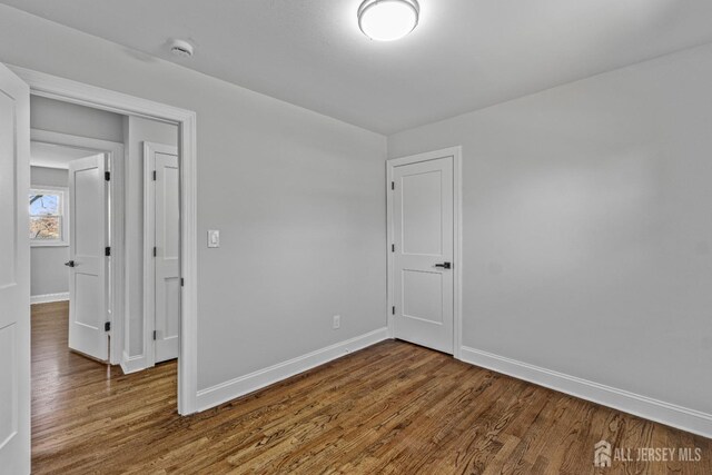 unfurnished room featuring hardwood / wood-style flooring