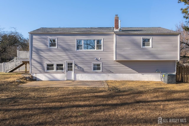 back of property featuring a yard, central AC, and a patio area