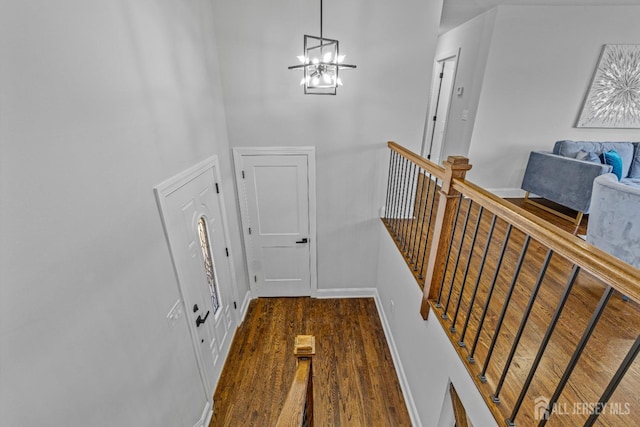 foyer featuring dark wood-type flooring and a chandelier