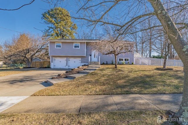 bi-level home with a front yard and a garage